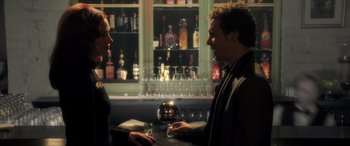 Movie still from “Confessions of a Dangerous Mind” (2002), directed by George Clooney – A man and a woman talking in front of a bar; Medium shot, Over the shoulder angle