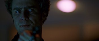 Movie still from “Confessions of a Dangerous Mind” (2002), directed by George Clooney – A man's face with the sun in the background; Extreme Close Up shot, Low angle