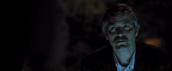 Movie still from “Confessions of a Dangerous Mind” (2002), directed by George Clooney – A person wearing a suit and tie; Close Up shot, Low angle