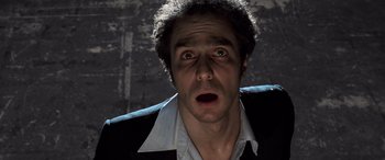 Movie still from “Confessions of a Dangerous Mind” (2002), directed by George Clooney – A person wearing a suit and tie; Close Up shot, Low angle