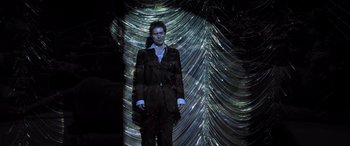 Movie still from “Confessions of a Dangerous Mind” (2002), directed by George Clooney – A man standing in front of a wall made out of foil; Wide shot, Low angle