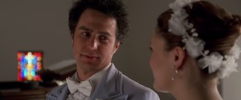 Movie still from “Confessions of a Dangerous Mind” (2002), directed by George Clooney – A person wearing a suit and a bow tie; Close Up shot, Over the shoulder angle