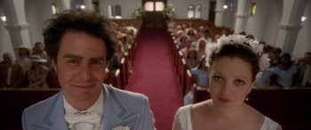 Movie still from “Confessions of a Dangerous Mind” (2002), directed by George Clooney – A man and a woman standing next to each other in front of an audience; Close Up shot, Low angle
