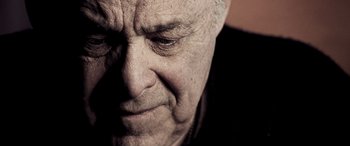 Movie still from “Confessions of a Dangerous Mind” (2002), directed by George Clooney – An old man with a beard is looking at the camera; Close Up shot, Low angle