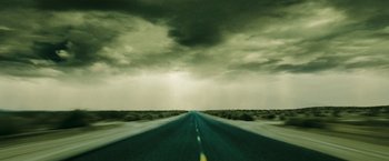 Movie still from “Confessions of a Shopaholic” (2009), directed by P.J. Hogan – A long empty road going through the middle of nowhere under a cloudy sky; Extreme Wide shot, Low angle