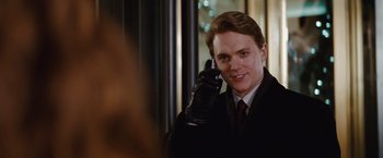 Movie still from “Confessions of a Shopaholic” (2009), directed by P.J. Hogan – A man in a suit and tie holding a cell phone to his ear; Close Up shot, Over the shoulder angle
