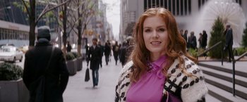 Movie still from “Confessions of a Shopaholic” (2009), directed by P.J. Hogan – A beautiful young woman in a pink top standing on the sidewalk; Close Up shot, Over the shoulder angle