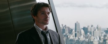 Movie still from “Confessions of a Shopaholic” (2009), directed by P.J. Hogan – A man standing in front of a window with a city view; Close Up shot, Over the shoulder angle