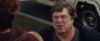 Movie still from “Confessions of a Shopaholic” (2009), directed by P.J. Hogan – An older man is looking at the camera; Close Up shot, Low angle