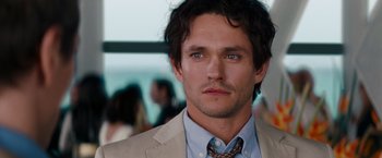 Movie still from “Confessions of a Shopaholic” (2009), directed by P.J. Hogan – A person wearing a suit and tie; Close Up shot, Over the shoulder angle