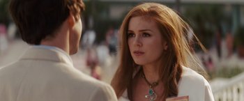Movie still from “Confessions of a Shopaholic” (2009), directed by P.J. Hogan – A person wearing a necklace near another person; Close Up shot, Over the shoulder angle
