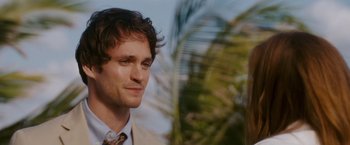 Movie still from “Confessions of a Shopaholic” (2009), directed by P.J. Hogan – A person wearing a suit and tie; Close Up shot, Over the shoulder angle