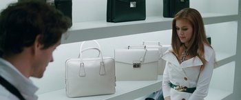 Movie still from “Confessions of a Shopaholic” (2009), directed by P.J. Hogan – A row of white leather briefcases on a shelf; Medium shot, Over the shoulder angle