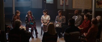 Movie still from “Confessions of a Shopaholic” (2009), directed by P.J. Hogan – A group of people sitting in a room; Wide shot, High angle