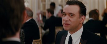 Movie still from “Confessions of a Shopaholic” (2009), directed by P.J. Hogan – A person wearing a suit and tie; Close Up shot, Over the shoulder angle