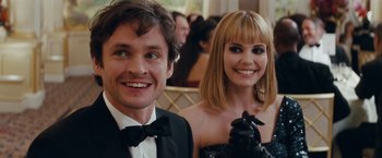 Movie still from “Confessions of a Shopaholic” (2009), directed by P.J. Hogan – A man and a woman posing for a picture; Close Up shot, Over the shoulder angle