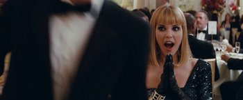 Movie still from “Confessions of a Shopaholic” (2009), directed by P.J. Hogan – A woman in a black dress and black leather gloves; Close Up shot, Over the shoulder angle