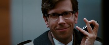 Movie still from “Confessions of a Shopaholic” (2009), directed by P.J. Hogan – A person wearing glasses and smiling; Close Up shot, Over the shoulder angle