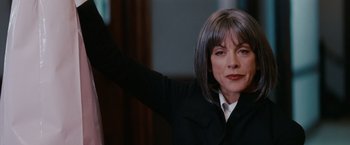 Movie still from “Confessions of a Shopaholic” (2009), directed by P.J. Hogan – A woman with grey hair waving at the camera; Close Up shot, Low angle
