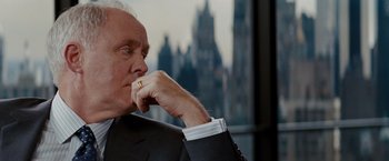 Movie still from “Confessions of a Shopaholic” (2009), directed by P.J. Hogan – An older man in a suit and tie looking off into the distance; Close Up shot, Over the shoulder angle