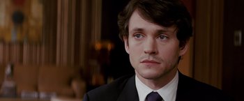 Movie still from “Confessions of a Shopaholic” (2009), directed by P.J. Hogan – A person wearing a suit and tie; Close Up shot, Over the shoulder angle