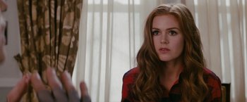 Movie still from “Confessions of a Shopaholic” (2009), directed by P.J. Hogan – A woman sitting in front of a window with her hair down; Close Up shot, Over the shoulder angle