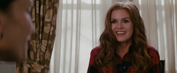 Movie still from “Confessions of a Shopaholic” (2009), directed by P.J. Hogan – A woman with long brown wavy hair wearing a red and black plaid shirt; Close Up shot, Over the shoulder angle