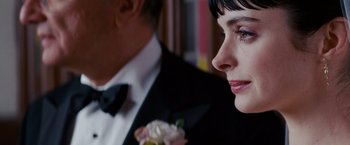 Movie still from “Confessions of a Shopaholic” (2009), directed by P.J. Hogan – A man and a woman in formal attire; Extreme Close Up shot, Over the shoulder angle