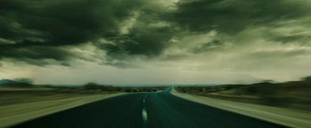 Movie still from “Confessions of a Shopaholic” (2009), directed by P.J. Hogan – A road that has a cloudy sky in the background; Extreme Wide shot, High angle
