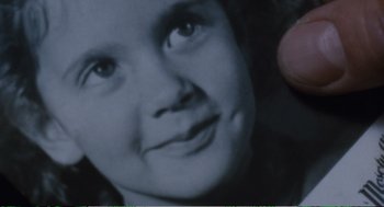 Movie still from “Confidence” (1980), directed by István Szabó – A black and white photo of a woman's face; Extreme Close Up shot, Overhead angle