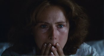 Movie still from “Confidence” (1980), directed by István Szabó – A person with their hands over their mouth; Close Up shot, Low angle