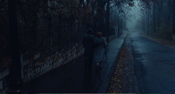 Movie still from “Confidence” (1980), directed by István Szabó – A man and a woman walking down the sidewalk; Wide shot, High angle