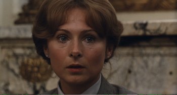 Movie still from “Confidence” (1980), directed by István Szabó – A person wearing a suit and tie; Close Up shot, Over the shoulder angle