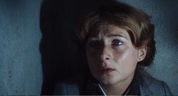 Movie still from “Confidence” (1980), directed by István Szabó – A person looking at the camera; Close Up shot, High angle