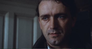 Movie still from “Confidence” (1980), directed by István Szabó – A person wearing a jacket; Close Up shot, Low angle