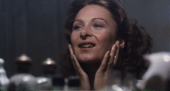Movie still from “Confidence” (1980), directed by István Szabó – A woman with her hands on her face looking up; Close Up shot, Over the shoulder angle