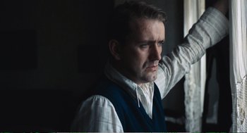 Movie still from “Confidence” (1980), directed by István Szabó – A person wearing a shirt and vest; Close Up shot, Low angle