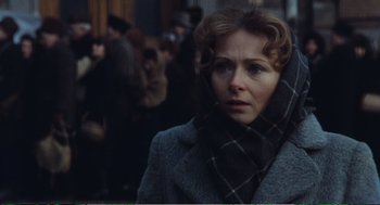 Movie still from “Confidence” (1980), directed by István Szabó – A person wearing a scarf; Close Up shot, Over the shoulder angle