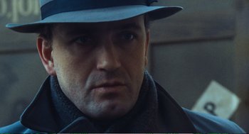 Movie still from “Confidence” (1980), directed by István Szabó – A person wearing a hat; Close Up shot, Low angle
