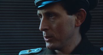 Movie still from “Confidence” (1980), directed by István Szabó – A person wearing a uniform; Close Up shot, Low angle