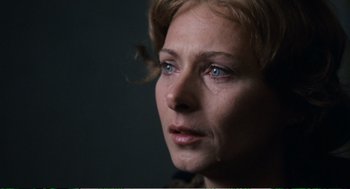 Movie still from “Confidence” (1980), directed by István Szabó – A woman's face with blue eyes; Close Up shot, Over the shoulder angle