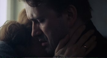 Movie still from “Confidence” (1980), directed by István Szabó – A person with their hands on his neck; Close Up shot, Low angle