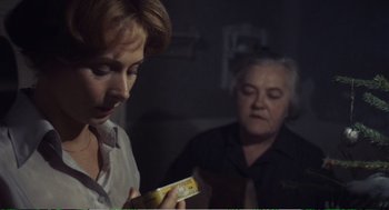 Movie still from “Confidence” (1980), directed by István Szabó – Two women are looking at a box of cheese; Close Up shot, Over the shoulder angle