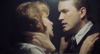 Movie still from “Confidence” (1980), directed by István Szabó – A man and a woman face to face in front of a mirror; Close Up shot, Low angle