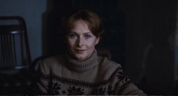 Movie still from “Confidence” (1980), directed by István Szabó – A woman wearing a sweater and looking at the camera; Close Up shot, High angle