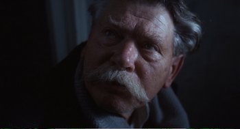 Movie still from “Confidence” (1980), directed by István Szabó – An older man with a mustache and a beard; Close Up shot, Low angle