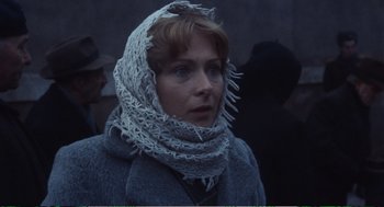 Movie still from “Confidence” (1980), directed by István Szabó – A woman wearing a scarf around her neck; Close Up shot, Low angle