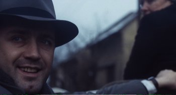 Movie still from “Confidence” (1980), directed by István Szabó – A person wearing a hat; Close Up shot, Over the shoulder angle