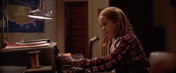 Movie still from “Contact” (1997), directed by Robert Zemeckis – A young girl sitting in front of a laptop computer; Medium shot, Low angle
