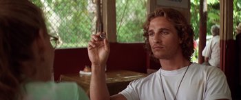 Movie still from “Contact” (1997), directed by Robert Zemeckis – A young man holding a camera in his hand; Close Up shot, Over the shoulder angle